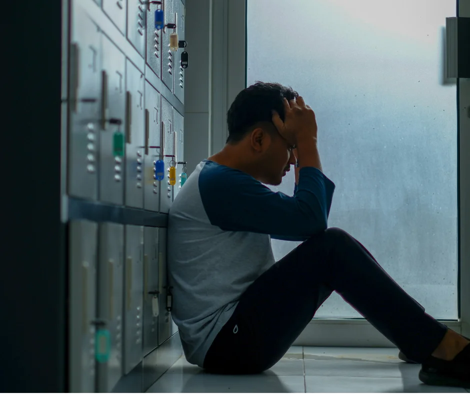a man sitting tensed representing emotionally down.