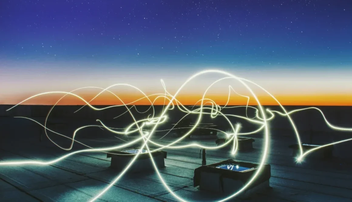 Light trails swirling under a twilight sky, symbolizing natural energy cycles and the rhythmic flow of peak performance linked to ultradian rhythms.
