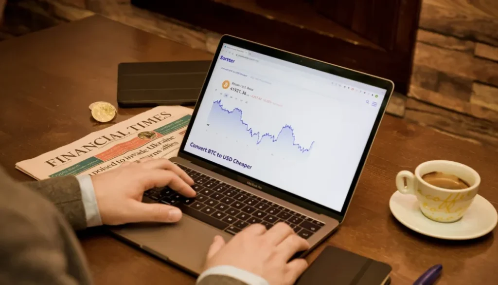 Man using a computer displaying stock market forecasts, representing the Barbell Strategy in investing