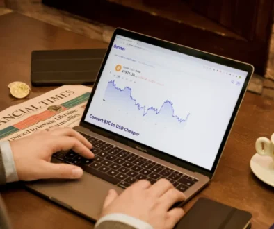 Man using a computer displaying stock market forecasts, representing the Barbell Strategy in investing