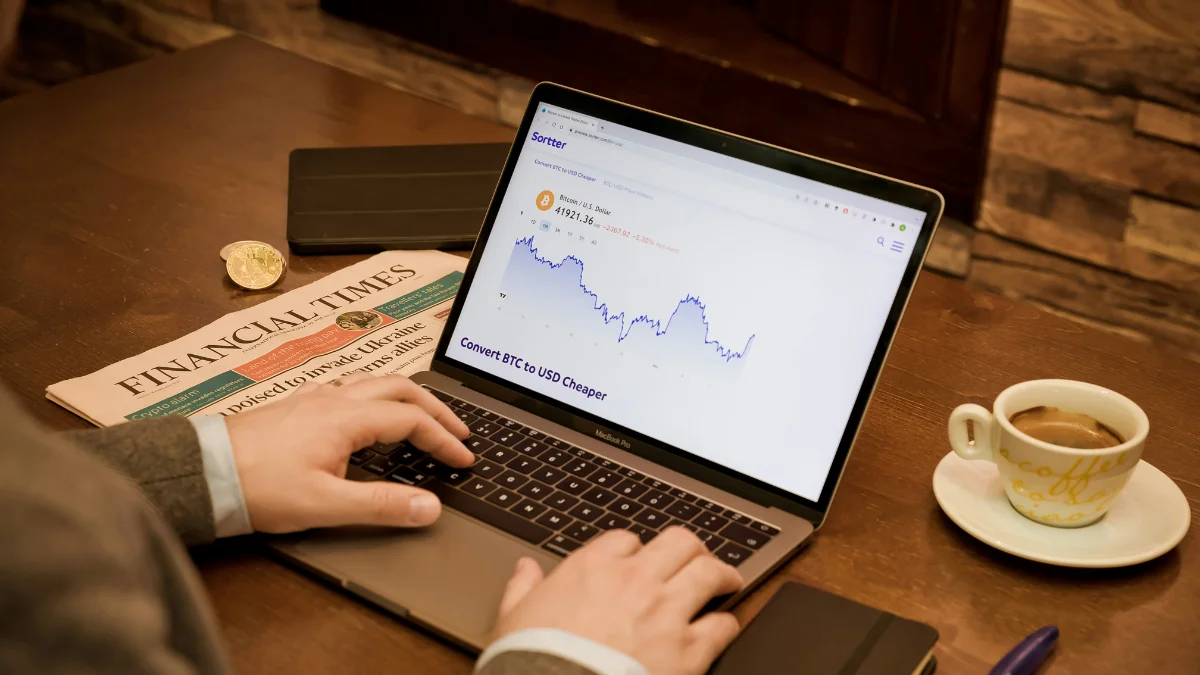 Man using a computer displaying stock market forecasts, representing the Barbell Strategy in investing